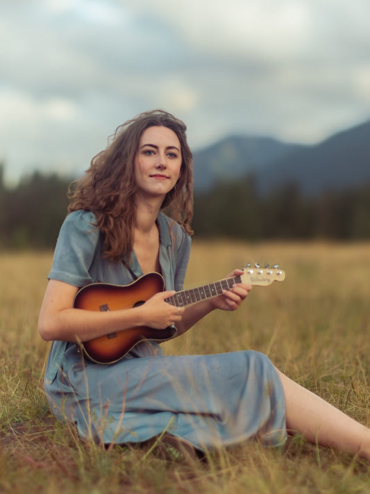 Singer-songwriter Irene Poole with her ukulele in a mountain meadow