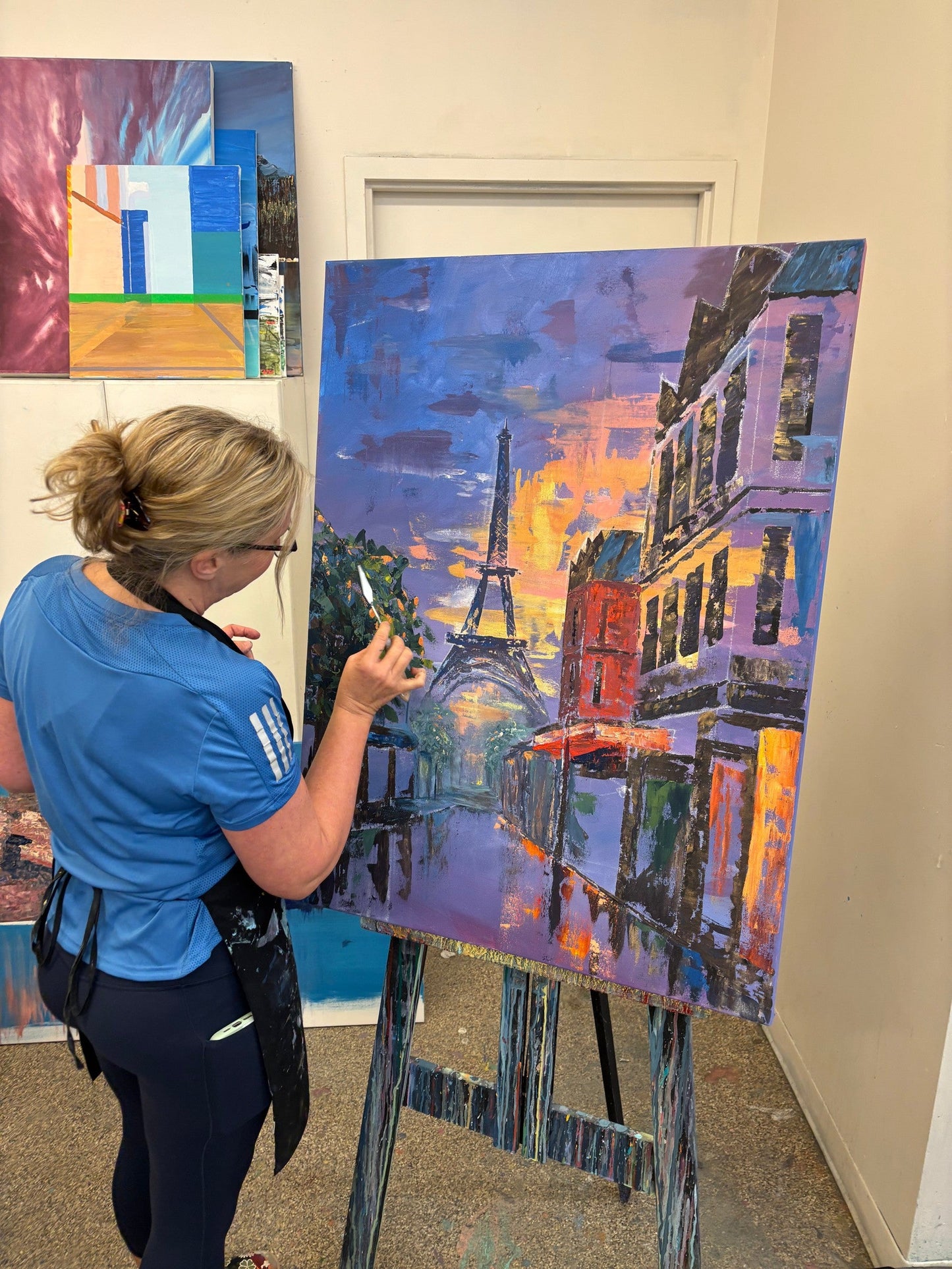 Student painting a Paris street cityscape in acrylic at the Cityscape Painting Workshop, Grasby Art Studio, NW Calgary