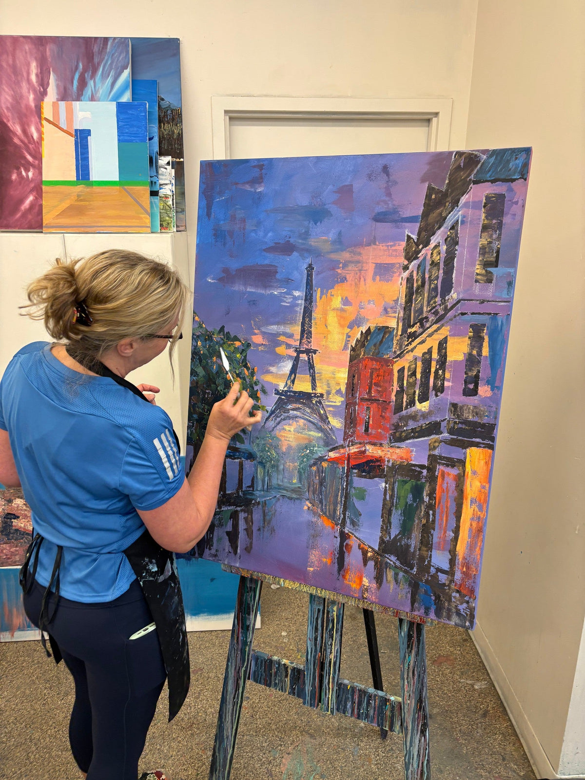 Student painting a Paris street cityscape in acrylic at the Cityscape Painting Workshop, Grasby Art Studio, NW Calgary